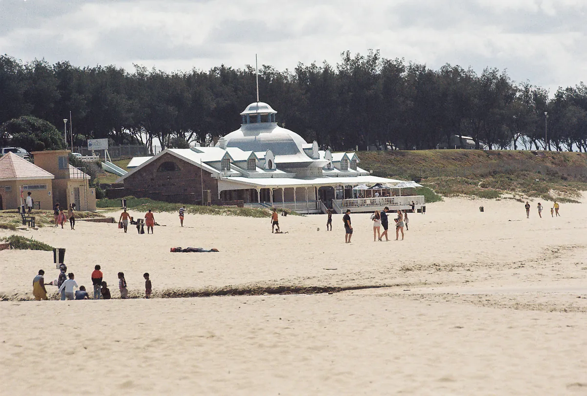 Santos Beach, Mossel Bay — pale sand with the domed white Santos Pavilion and milkwood trees behind