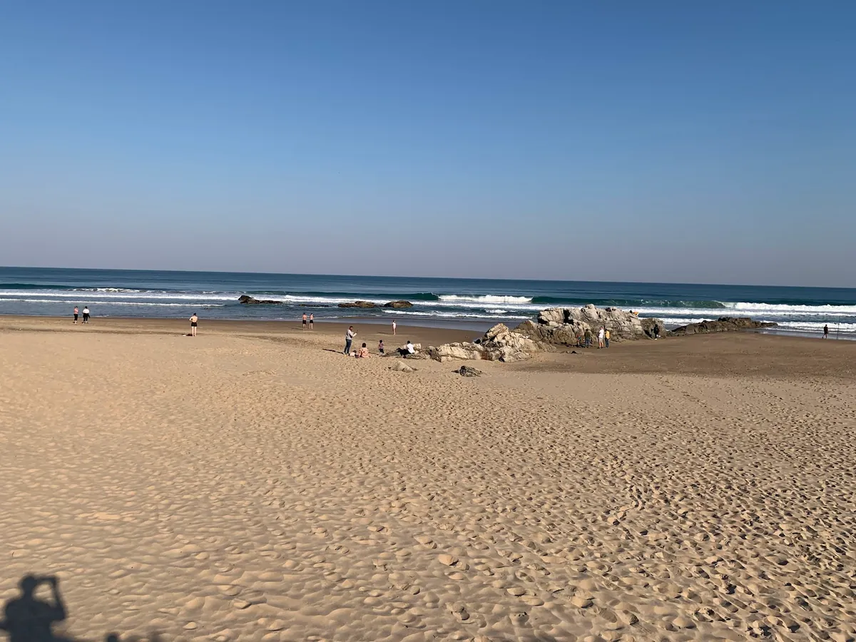 Wide sandy beach at Wilderness on the Garden Route in the shoulder season, gentle surf, almost empty shore, South Africa